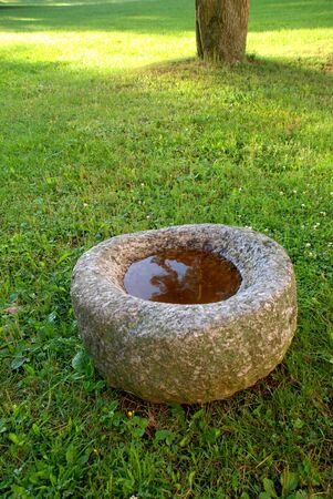 Ancient stone with the pool in the hollow の写真素材