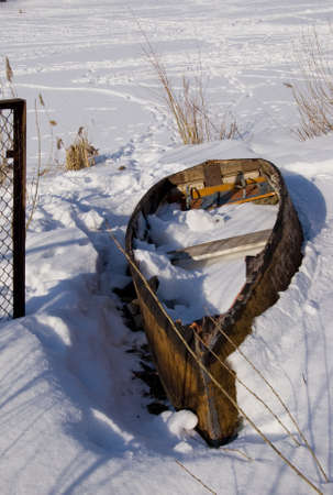 Old broken wooden boat resting on the coast of river.の写真素材