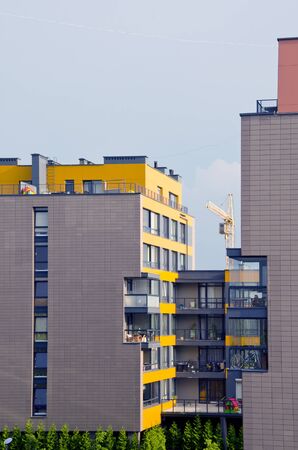 Newly build modern houses. Residential building with many flats. Construction industry crane.のeditorial素材