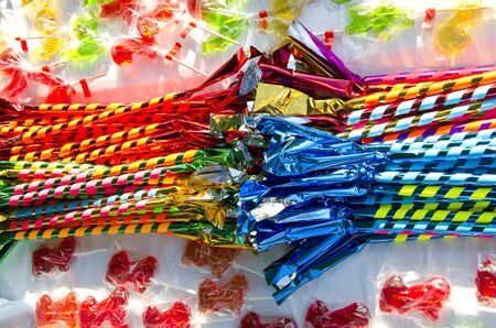 Table loaded with multicolored candies sold in outdoor fair. の写真素材