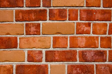 Background of red color brick wall closeup. Different tinge colors. 
