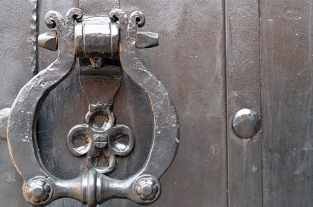 Vintage metal door handle  Ancient architecture background  