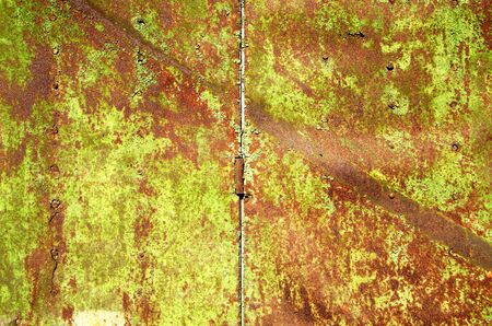 Background of old rusty steel garage door and hinge  