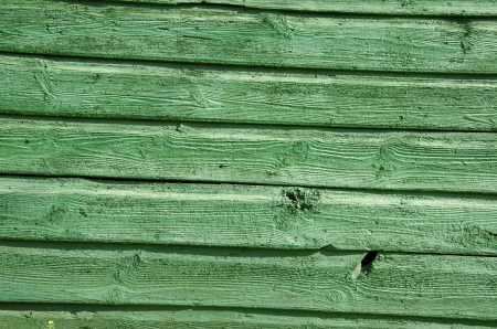Background of old wooden board wall painted green closeup. の写真素材