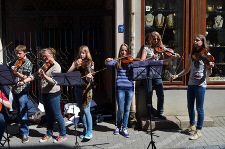 VILNIUS, LITHUANIA MAY 2012. Young people playing violin in street music day in Old Town street. Free event. のeditorial素材