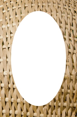 Isolated white oval place for text photograph image in center of frame. Wicker fragment background. Handmade interesting wooden backdrop. の写真素材