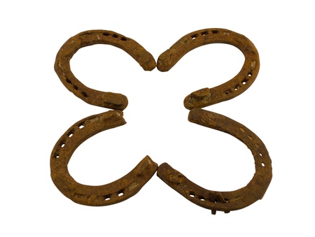 Concept of four leaf clover made of rusty retro horseshoes isolated on white background  Luck...