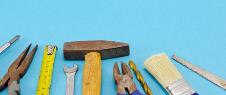 various construction work tools hammer meter chisel wrench pincers screwdriver brush bit on blue background  の写真素材