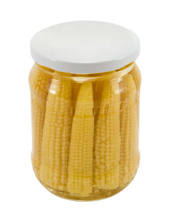 glass jar of preserved ecological natural healthy mini corn ears isolated on white background の写真素材