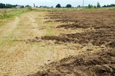 agricultural partly plowed field ground soil in autumn  