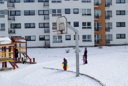 VILNIUS, LITHUANIA - FEBRUARY 26: childrens backyard basketball court in the winter small children with nannies on February 26, 2013 in Vilnius. のeditorial素材