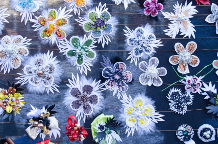 various cute handmade women jewelry decorations brooch pin breast-pin sold in outdoor street market fair  の写真素材