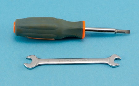 screwdriver turn-screw spanner tommy wrench construction work hand tools on blue background  
