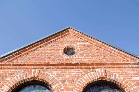 small round window and arch in retro architecture red brick building house roof on background of...