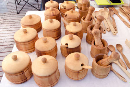 wooden handmade sugar basin spice mortar and other kitchen utensil tools sold in outdoor street market fair. の写真素材
