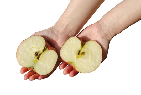 woman holds palms sawn ripe apple sides with small brown seeds の写真素材