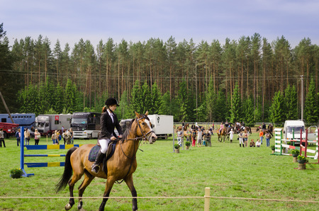 NIURONYS, LITHUANIA - JUNE 01: woman ride horse in horserace steeplechase competition on June 01, 2013 in Niuronys, Lithuania. のeditorial素材