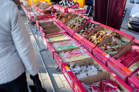 BIRZAI, LITHUANIA - OCTOBER 05: various sweets and candies on sale at market fair bazaar and people customers on October 05, 2013 in Birzai. のeditorial素材