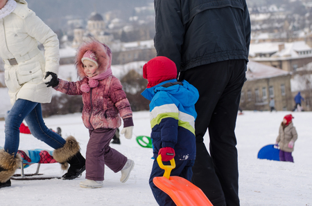 VILNIUS, LITHUANIA - JANUARY 18: children with parents playing in the winter park on January 18, 2014 in Vilnius, Lithuania. Winter landscape.  のeditorial素材