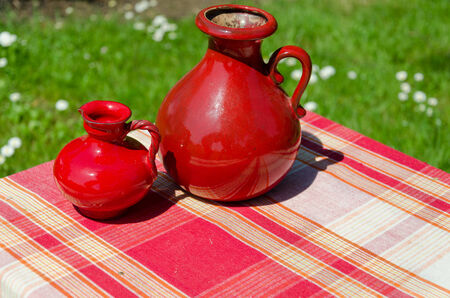 large and small red retro vintage clay jugs outdoorの写真素材