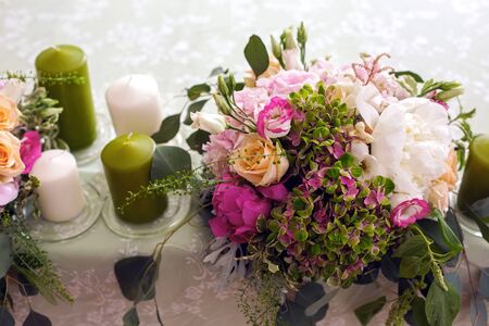 Wedding table setting with green candle and flowersの写真素材