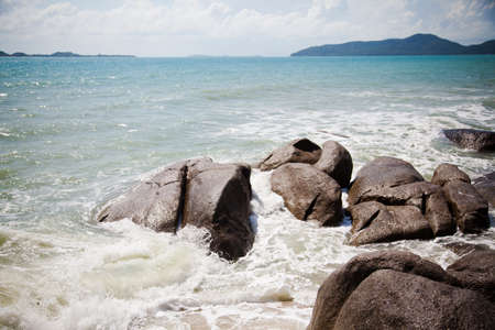 large rocks washed by the ocean in Thailandの写真素材