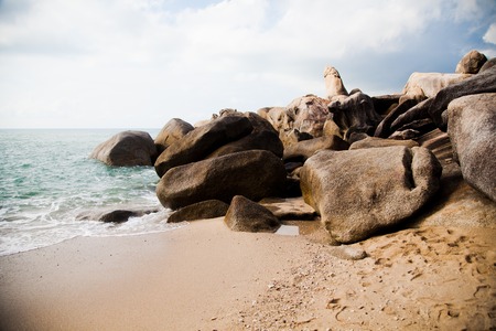 large rocks washed by the ocean in Thailandの写真素材