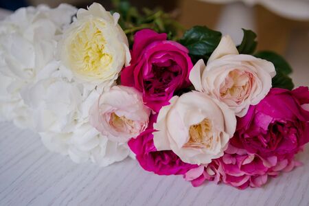 bouquet of peonies, hydrangeas and roses lying on the white tableの写真素材