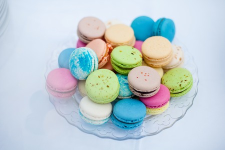 colorful cookies French macaroons on a white plateの写真素材