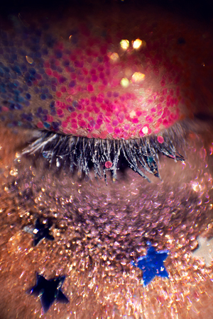 painted eyes different colors young girl in a macroの写真素材