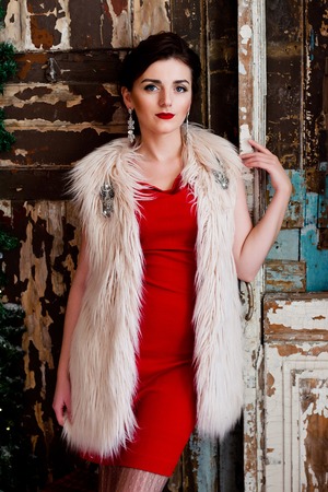 portrait of a young girl in a red dress in the Studioの写真素材