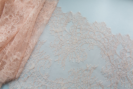 peach lace lying on a white backgroundの写真素材