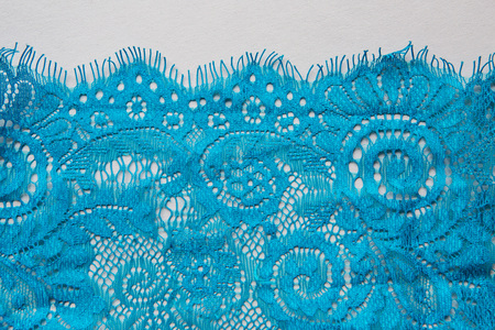 blue lace lying on a white backgroundの写真素材
