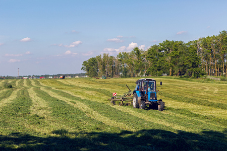 Pushkin, Russia - 2 July : on a green field in summer, the tractor leveled the grass fresh grass in celebration of World UFO Day on 2 July, 2016.のeditorial素材