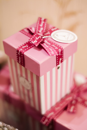 paper pink striped box with a scarlet ribbon at the festivalの写真素材