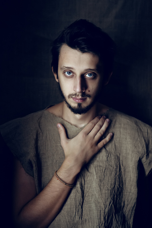 portrait of a serious young guy with a beard and a mustache shirt grey flaxの写真素材