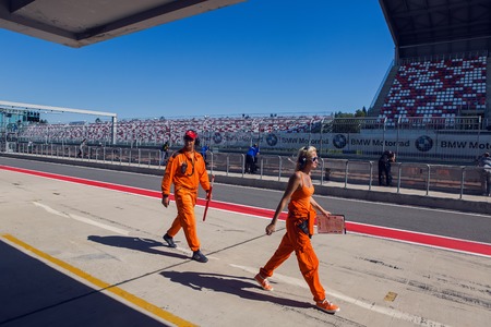 Moscow region, Russia - 27 August : route Moscow raceway technical staff male and female in an orange jumpsuit , the clothes are on the inner track in day of Russian cinema 27 August, 2016.のeditorial素材