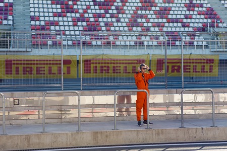 Moscow region, Russia - 27 August : route Moscow raceway technical staff male in an orange jumpsuit , the clothes are on the inner track in day of Russian cinema 27 August, 2016.のeditorial素材