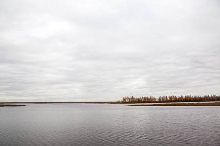 panorama of lake with autumn trees in the background in St. Petersburgの写真素材