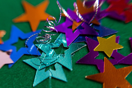 small multi-colored stars on a green backgroundの写真素材