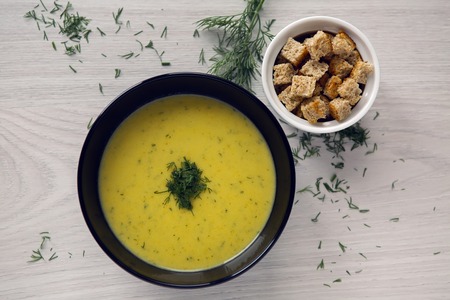 soup puree of zucchini in a black plateの写真素材