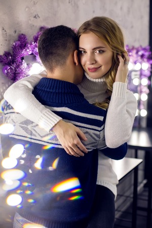 the guy with the blonde girl in sweaters kissing in the blue roomの写真素材
