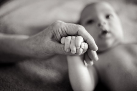 grandmother holds the hand of his beloved grandsonの写真素材