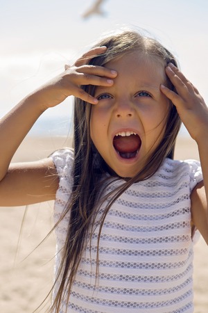 portrait of a tanned girl on the sandy beach