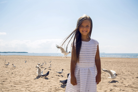 portrait of a tanned girl on the sandy beachの写真素材