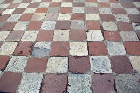 old square tiles in a checkerboard pattern lying on the area of Montenegro in Kotor