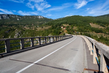 long road on the bridge in the mountains of Montenegroの写真素材