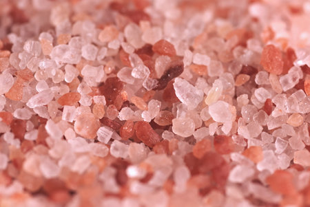 Himalayan pink salt crystals close up macro photo. Natural bath salt background.