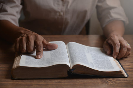 Woman reads the Bible with devotion, seeking guidance from Jesus Christ and God in her religion....