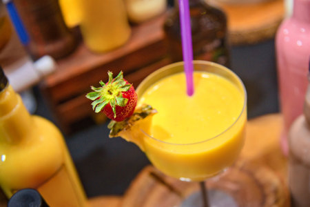 Alcoholic beverage called: Batida de Manga, a drink with a strong alcoholic content, with a glass decorated with a strawberry. Brazilian beverageの写真素材